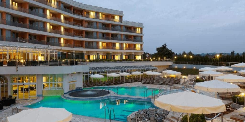 Hotel Livada Prestige elegant exterior with thermal pools surrounded by lush greenery in Moravske Toplice