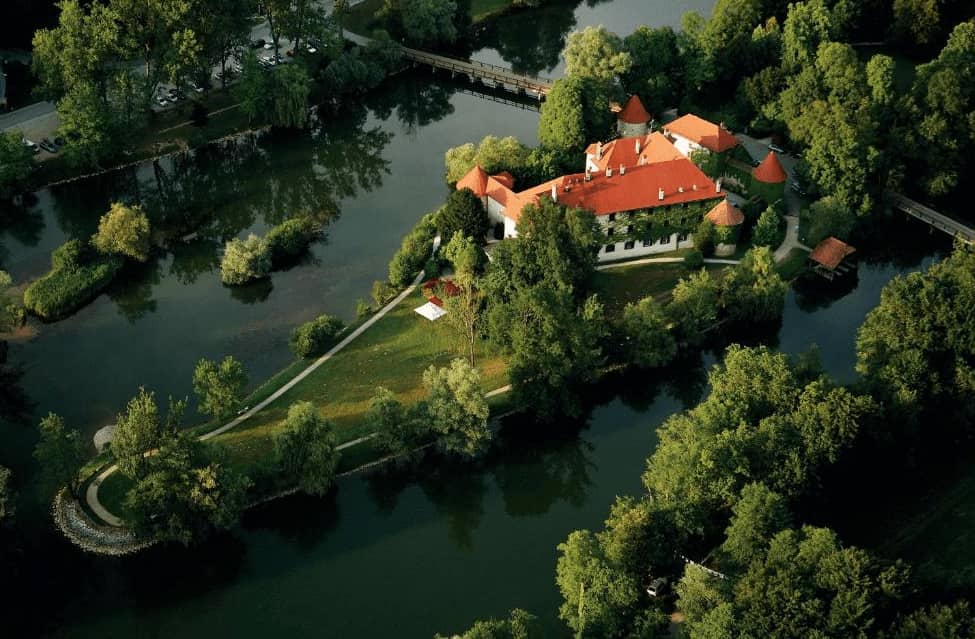 Grad Otočec Castle-Most romantic Hotels perched on a riverside islet, surrounded by moat and lush Slovenian forest