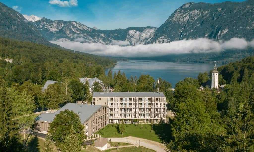 Lake Bled vs Bohinj Luxury Stays. Beautiful view of lake Bohinj and hotel.