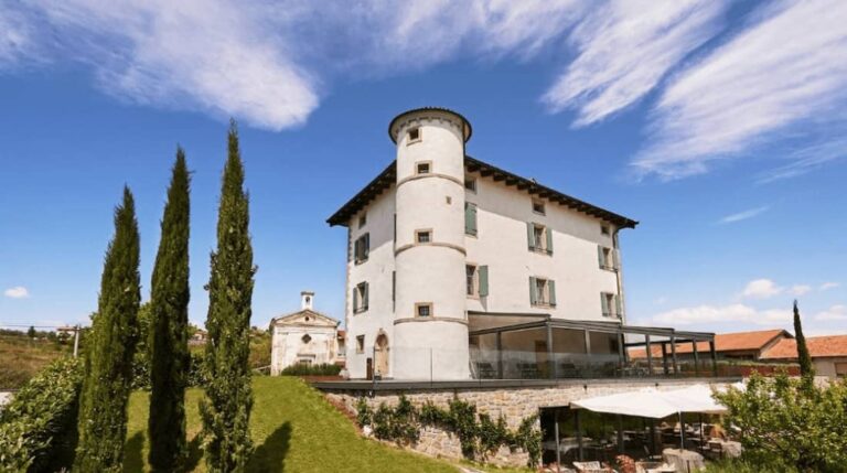 Best Wine Hotels in Slovenia. Gredič castle surrounded by vineyards in Goriška Brda, Slovenia, with panoramic views of the hills and a serene atmosphere.