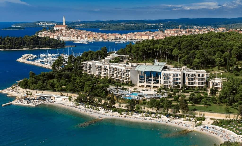 Slovenia vs Croatia luxury hotels. Beach, hotel, city behind and landscape view.