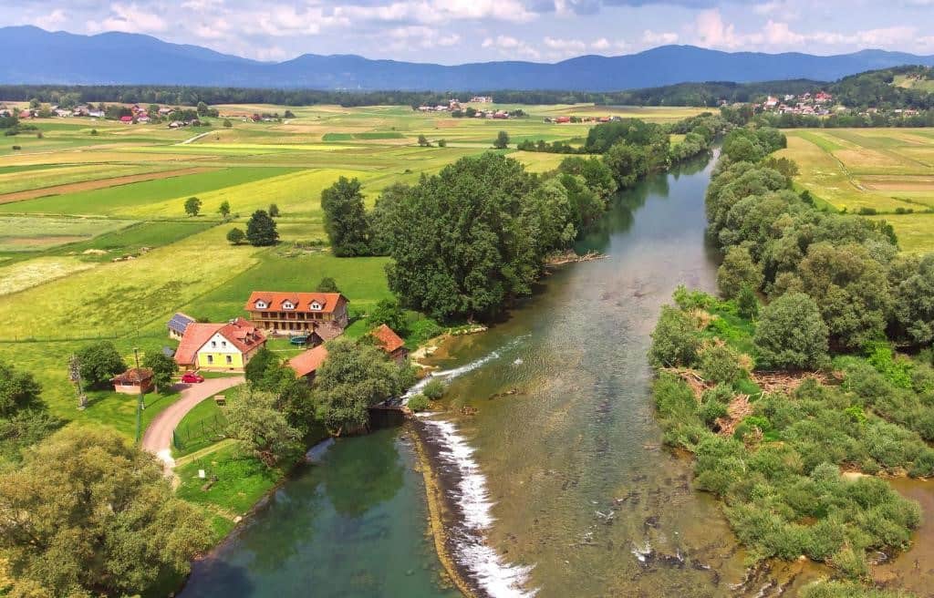 Luxury Farm Stays Slovenia. River Colpa and landscape from the air.