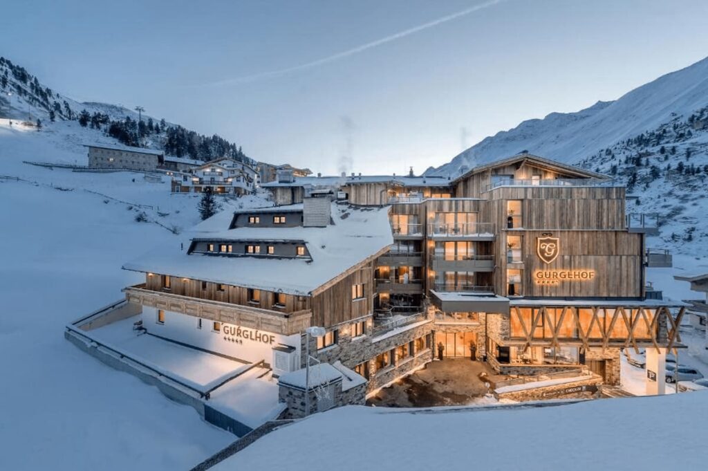 Luxury Ski-In Ski-Out Hotels Tyrol. Fascinating evening view of the hotel surrounded by snow.