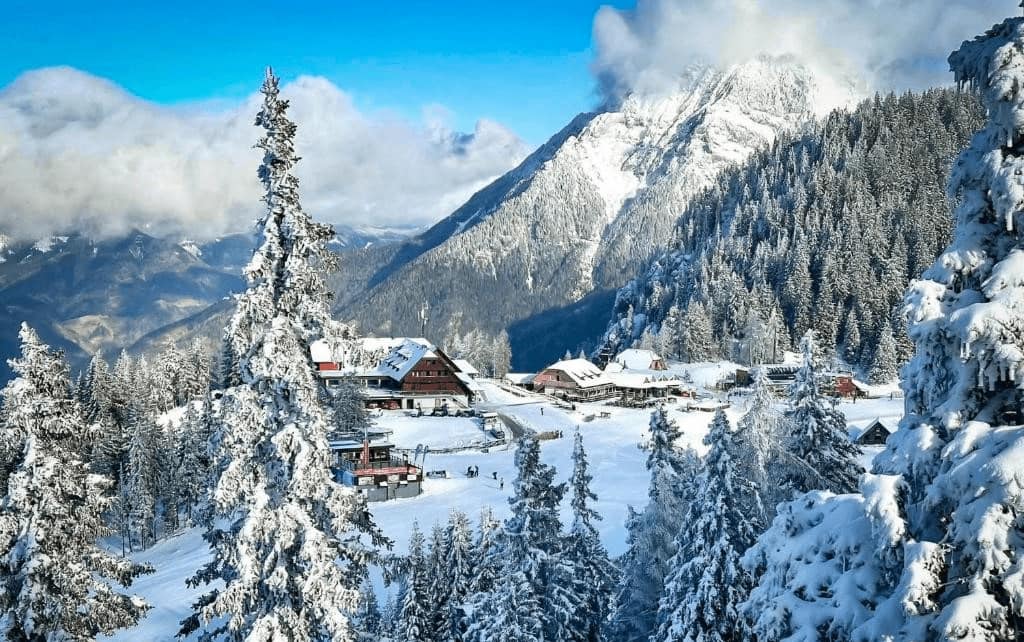 Best Ski Hotels in Krvavec. Winter view of hotel and slope.