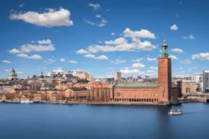 Distant skyline view of Stockholm City Hall and its Three Crowns tower, the architectural anchor for the best historic hotels in Sweden.