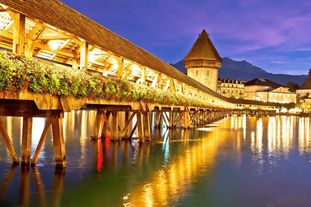 The 14th-century Chapel Bridge in Lucerne, the definitive architectural landmark for best historic hotels in Switzerland.