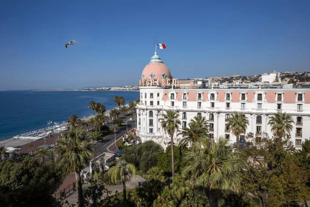 The historic facade of Hotel Negresco, one of the best hotels in Nice, overlooking the sea.