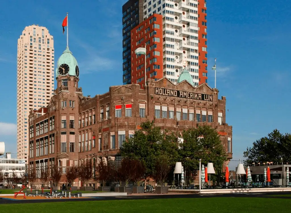 The iconic twin towers and Jugendstil brick facade of Hotel New York, the former Holland-America Line headquarters, representing the maritime soul and the best hotels in Rotterdam.