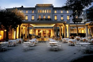 The grand 19th-century neoclassical front facade of the Baur au Lac, a 1844 family-owned landmark and the most recognizable of the best hotels in Zurich.