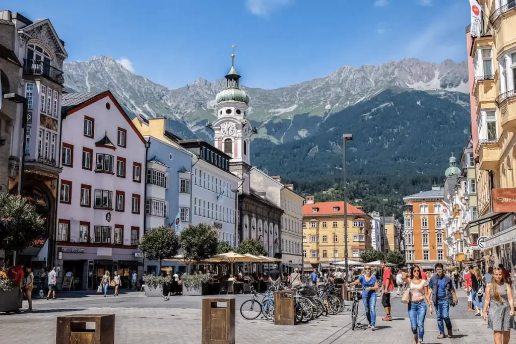 A street view of the medieval Gothic arcades in the Old Town, featuring the best hotels in Innsbruck for travelers seeking authentic historic heritage.