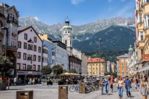 A street view of the medieval Gothic arcades in the Old Town, featuring the best hotels in Innsbruck for travelers seeking authentic historic heritage.