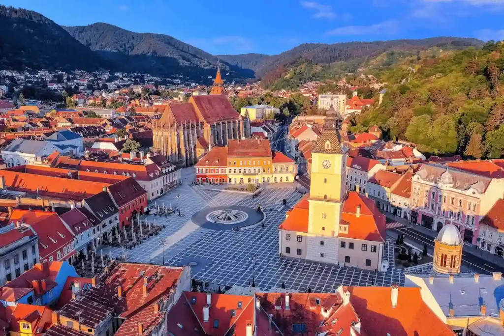 The 14th-century Gothic spires of the Black Church and Council Square, iconic national landmarks near the best historic hotels in Romania.