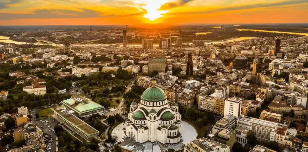 An audit of best historic hotels in Serbia: The monumental white marble facade and golden domes of the Saint Sava Temple, Belgrade's most iconic landmark.