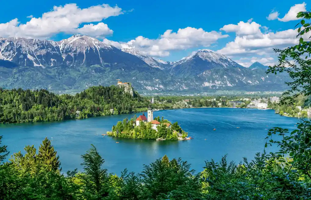An audit of best historic hotels in Slovenia: The 17th-century Baroque Pilgrimage Church of the Assumption of Mary on Bled Island, featuring the 99-step stone staircase and 1534 Wishing Bell.