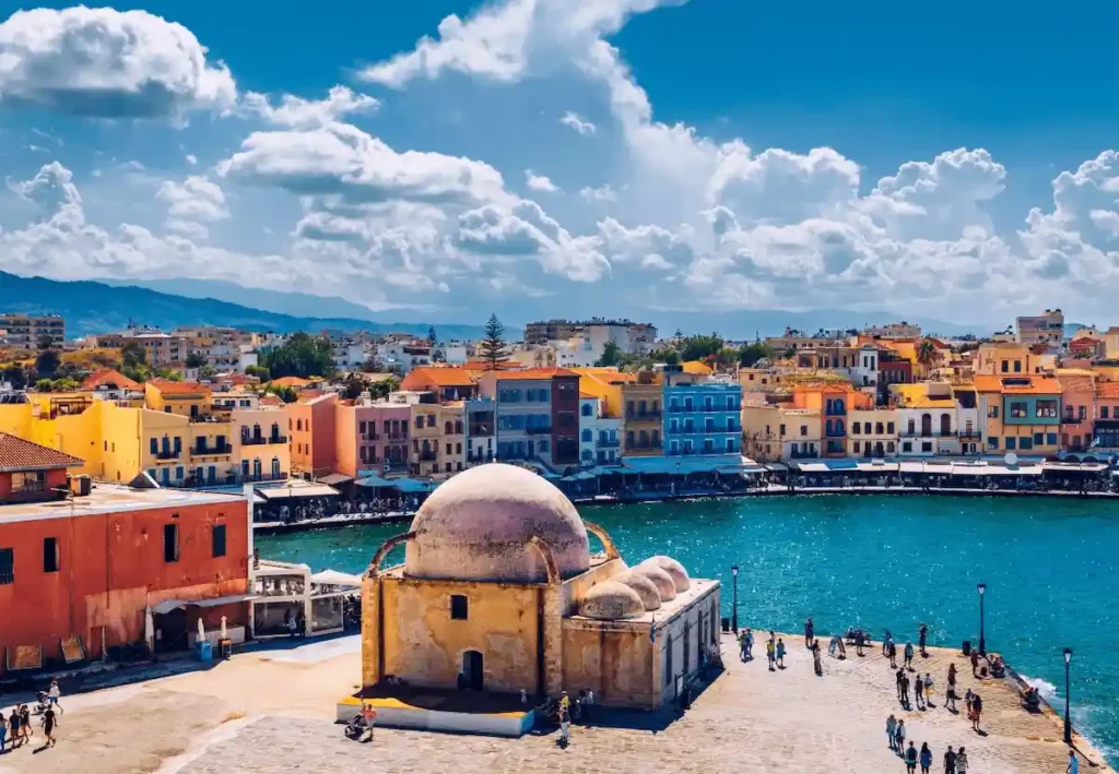 The pink-domed 17th-century Küçük Hasan Pasha Mosque (Mosque of the Janissaries) at the Old Venetian Harbor, a primary landmark near the best hotels in Chania.