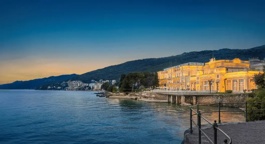 Best hotels in Opatija: The restored 1884 neoclassical facade of Hotel Kvarner and its grand terrace overlooking the Adriatic Sea and Lungomare promenade.