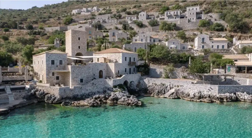 The fortified 18th-century stone tower facade of Pirgos Mavromichali, a former military stronghold and one of the best hotels in Peloponnese.