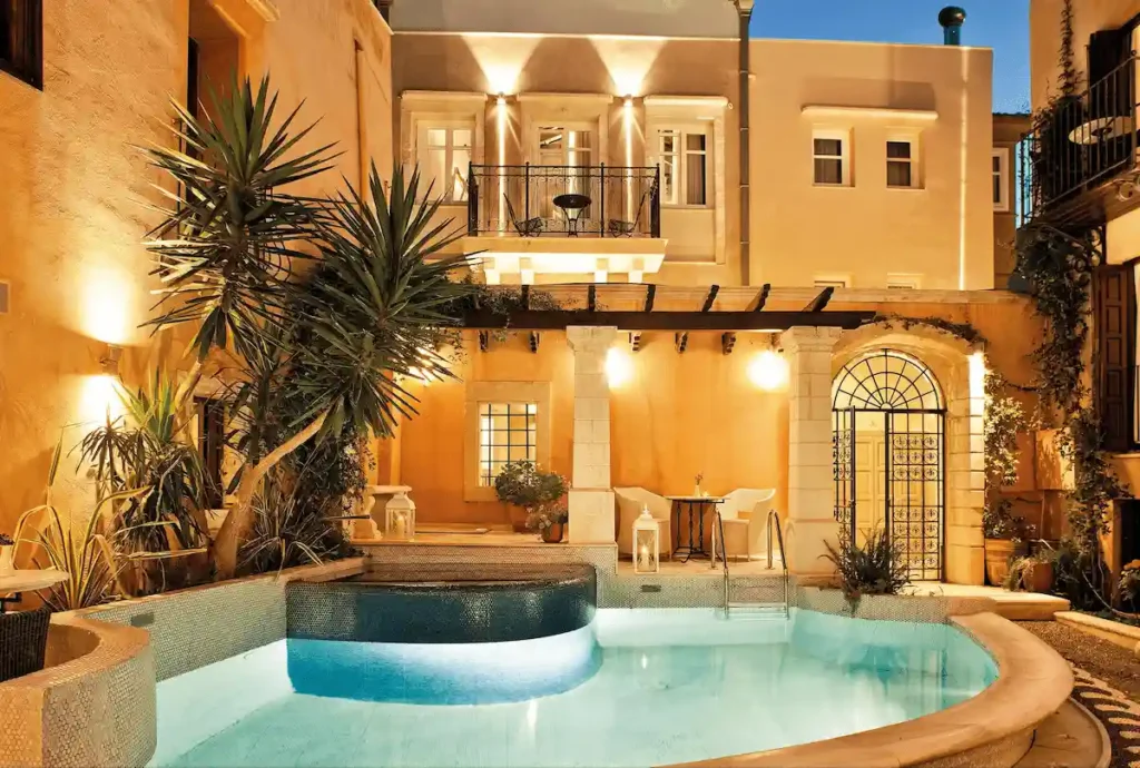 The 17th-century Venetian facade and internal courtyard pool of Rimondi Boutique Hotel, a premier asset among the best hotels in Rethymno Crete.