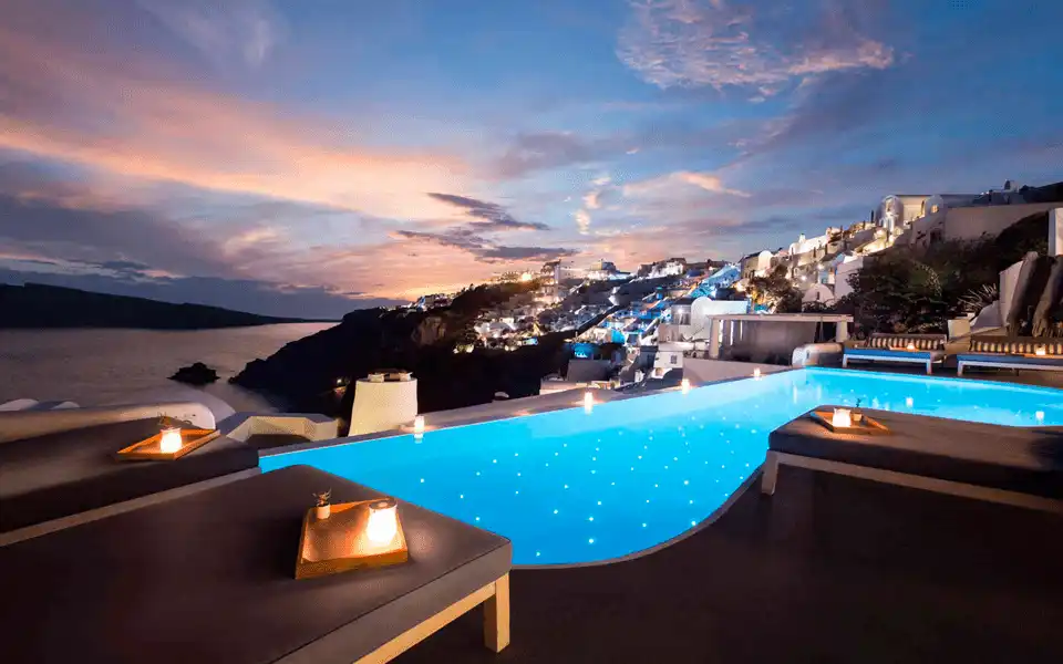 The panoramic infinity pool and caldera view at Katikies Garden, a 19th-century Catholic monastery landmark and one of the best hotels in Santorini.
