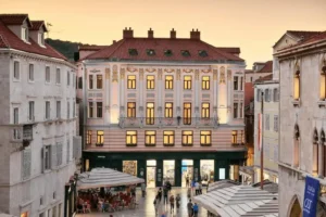 Best hotels in Split: The pink-toned 1906 Art Nouveau facade of the Piazza Heritage Hotel, originally the Nakic Palace, featuring its ornate Viennese-style balconies on the Pjaca square.