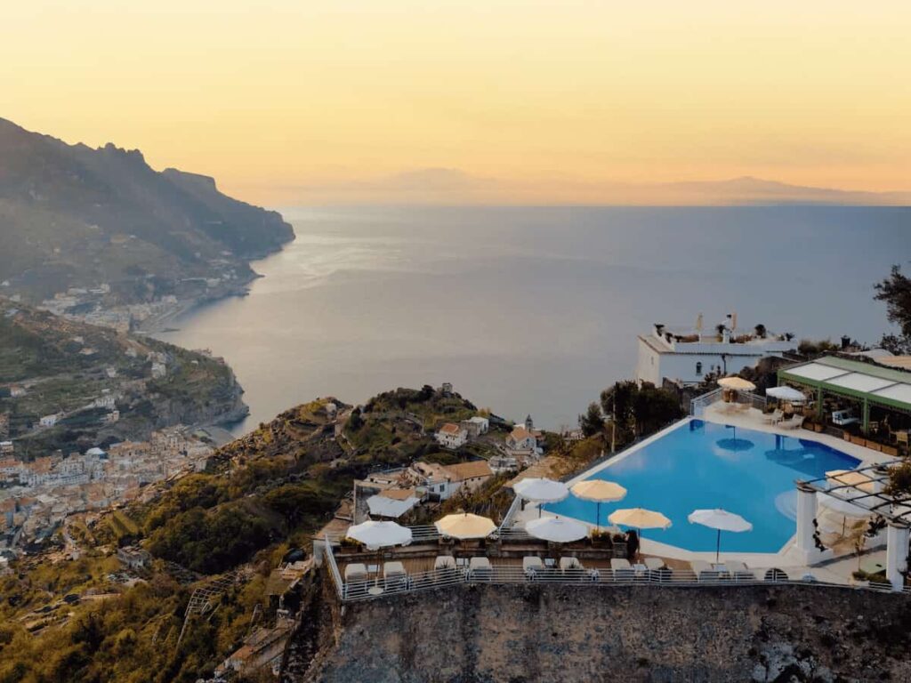 The famous infinity pool at Caruso, A Belmond Hotel, Amalfi Coast - perched high on a Ravello cliff with an expansive sunset view over the Amalfi Coast and the sea.