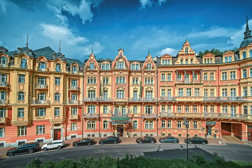 The vibrant and grand multi-building facade of the Carlsbad Plaza Karlovy Vary, showcasing its prestigious Five-Star Superior status under a clear blue sky.