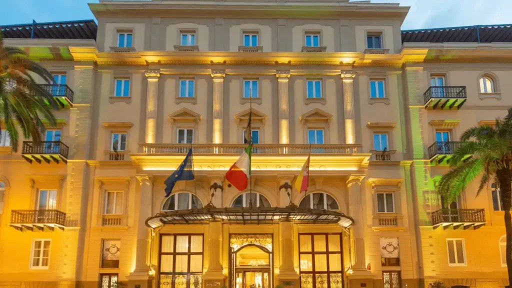 Exterior facade of the Grand Hotel et des Palmes in Palermo, a luxury landmark originally built in 1874 as the private residence of the Ingham-Whitaker banking dynasty and later transformed into a Belle Époque masterpiece.