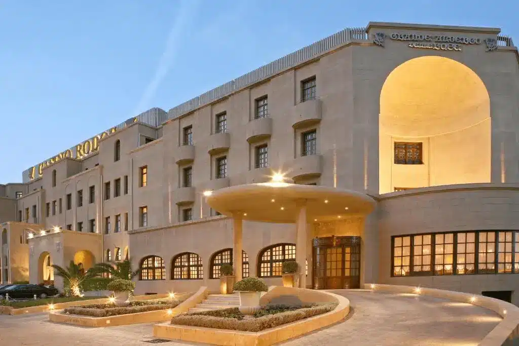 The grand stone exterior of the Grande Albergo Delle Rose in Rhodes, a 1927 Italian landmark and former site of the 1949 Arab-Israeli Armistice negotiations.