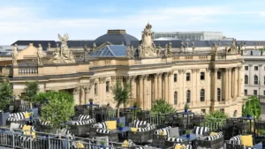 The expansive rooftop terrace of Hotel de Rome Berlin, a Rocco Forte Hotel, featuring stylish lounge furniture and panoramic views over Bebelplatz, the State Opera House, and the historic skyline of Berlin-Mitte.