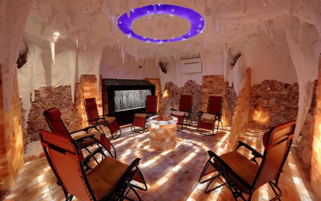 The specialized salt cave at Luxury Spa Hotel Olympic Palace, featuring reclining chairs and atmospheric lighting for respiratory and relaxation therapy.