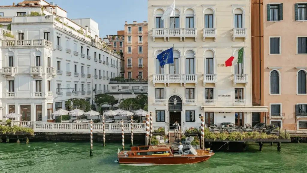 Aerial view of the Grand Canal entrance to The St. Regis Venice, highlighting the five-palazzo configuration built on the 1676 site of Teatro Sant'Angelo where Vivaldi premiered his operas.