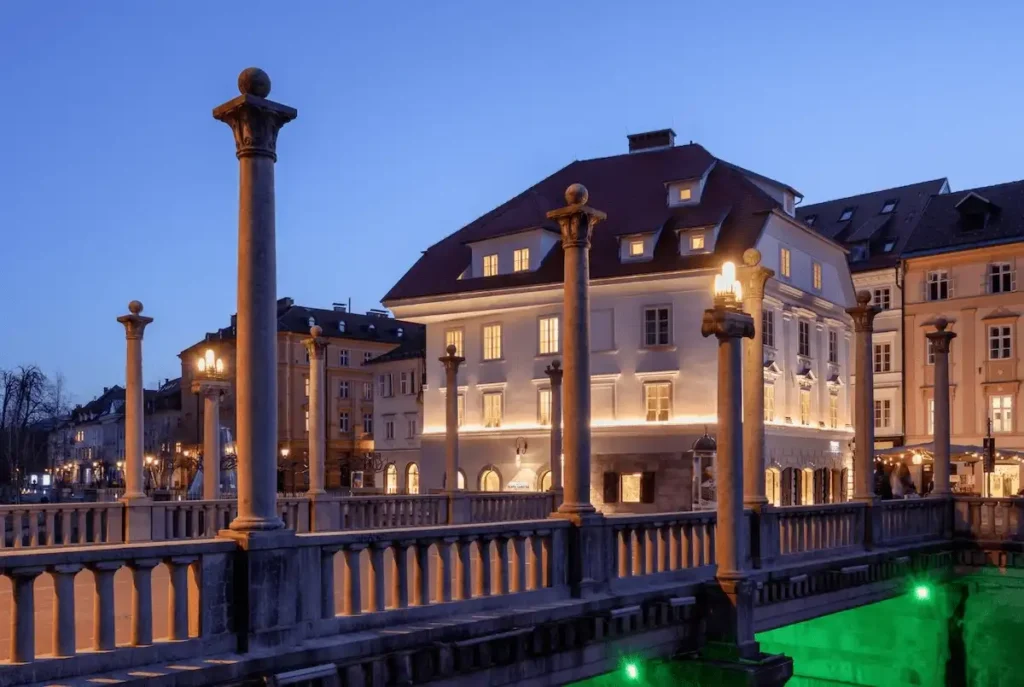 Exterior of Zlata Ladjica Boutique Hotel in Ljubljana, a meticulously restored 16th-century heritage building on the banks of the Ljubljanica river, featuring 15 uniquely themed rooms and a private wellness spa.